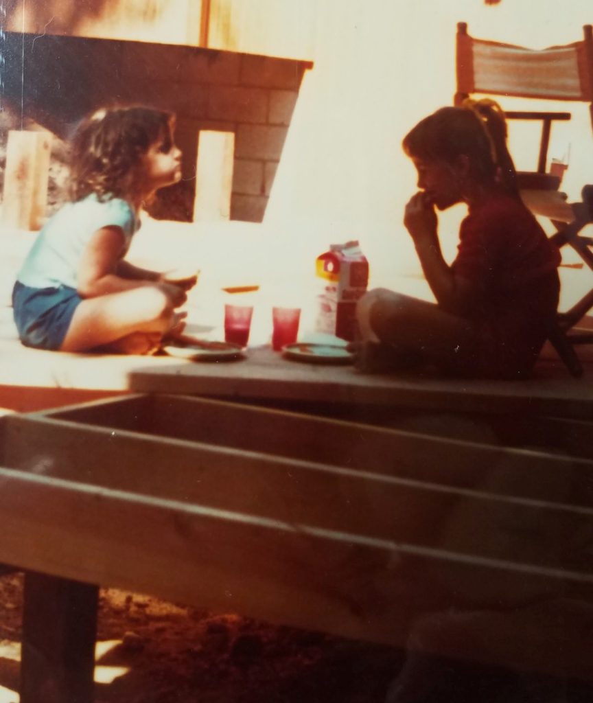 childhood photo of kids having lunch on a deck under construction